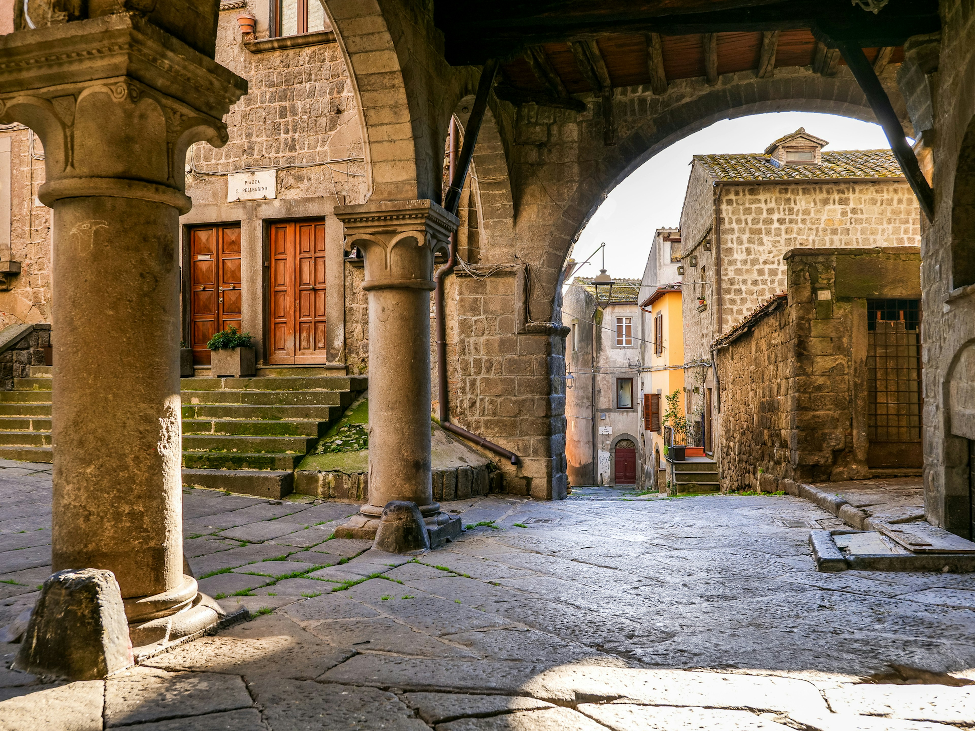 The beautiful stone portico in the square of San Pellegrino in the medieval heart of Viterbo in central Italy.