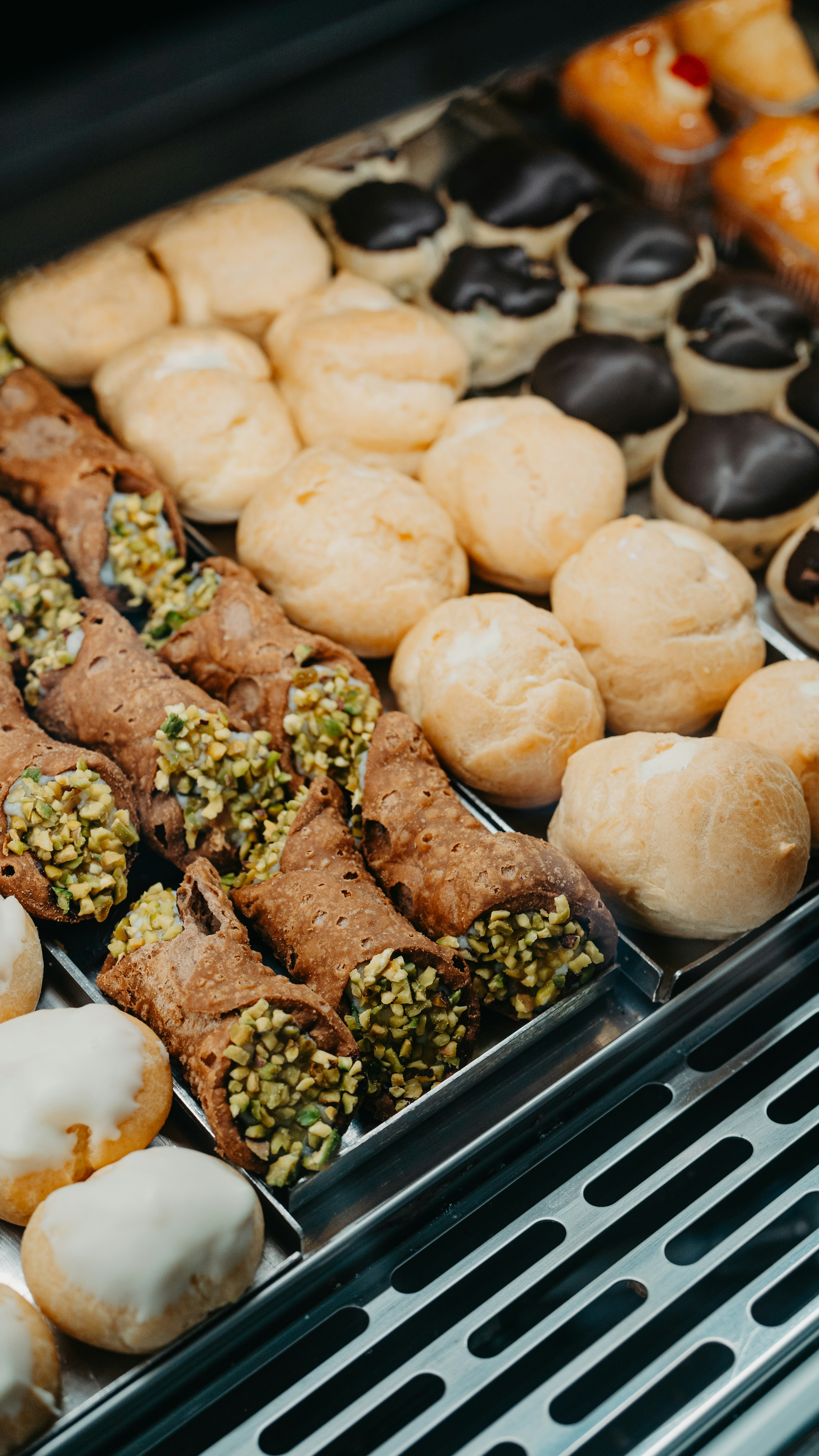 Different types of local and Italian pastry: lobster tails, bignè, cannoli siciliani, and others
August 2024: Lecce, Puglia, Italy